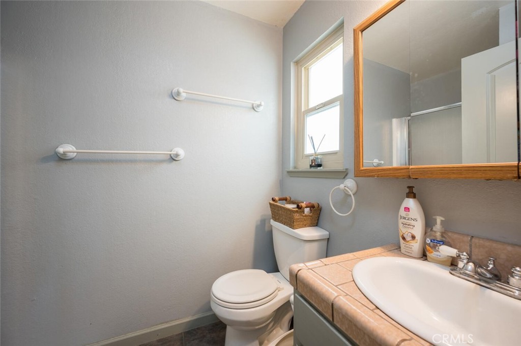 1503 17th Street Los Osos, CA 93402 - Photo 25 of 35 a bathroom with a sink a toilet and a mirror