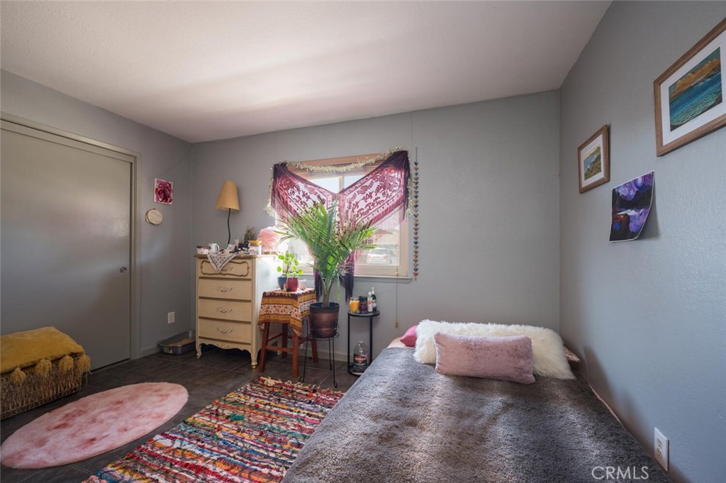 1503 17th Street Los Osos, CA 93402 - Photo 26 of 35 a bedroom with furniture and a potted plant