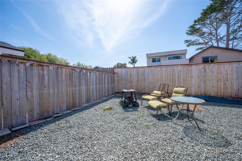 1503 17th Street Los Osos, CA 93402 - Photo 33 of 35 a backyard of a house with lawn chairs and wooden fence
