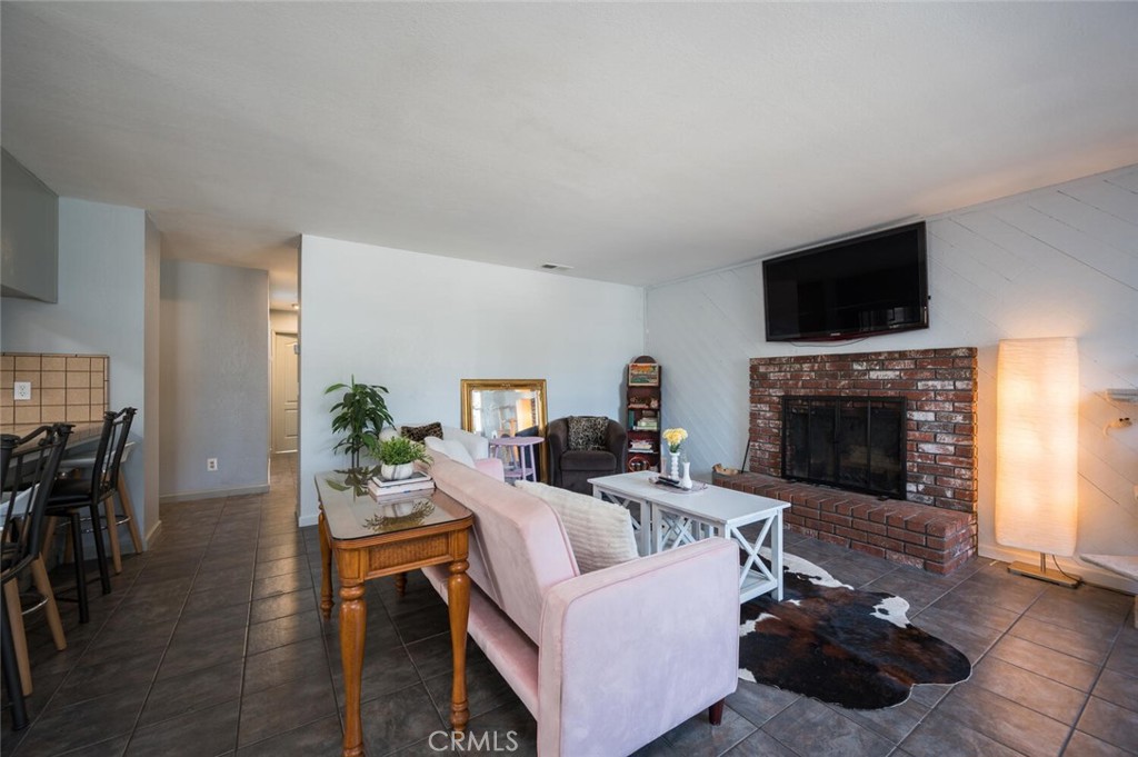 1503 17th Street Los Osos, CA 93402 - Photo 8 of 35 a living room with furniture a flat screen tv and a fireplace