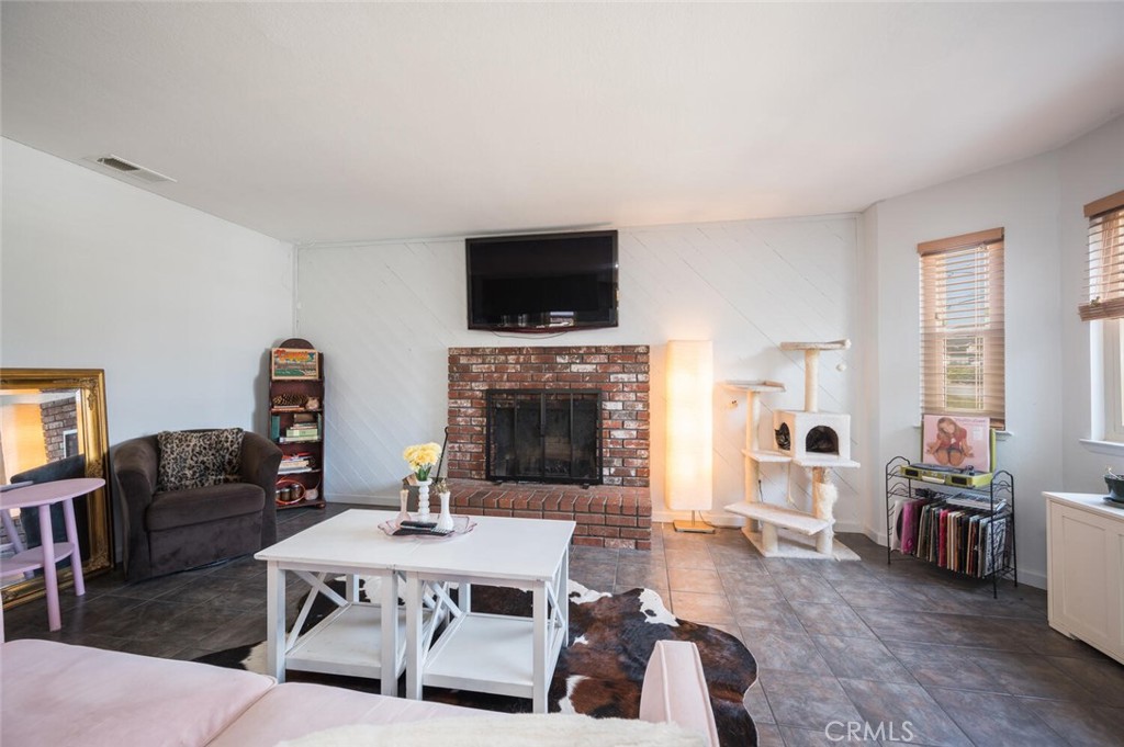 1503 17th Street Los Osos, CA 93402 - Photo 9 of 35 a living room with furniture a flat screen tv and a fireplace
