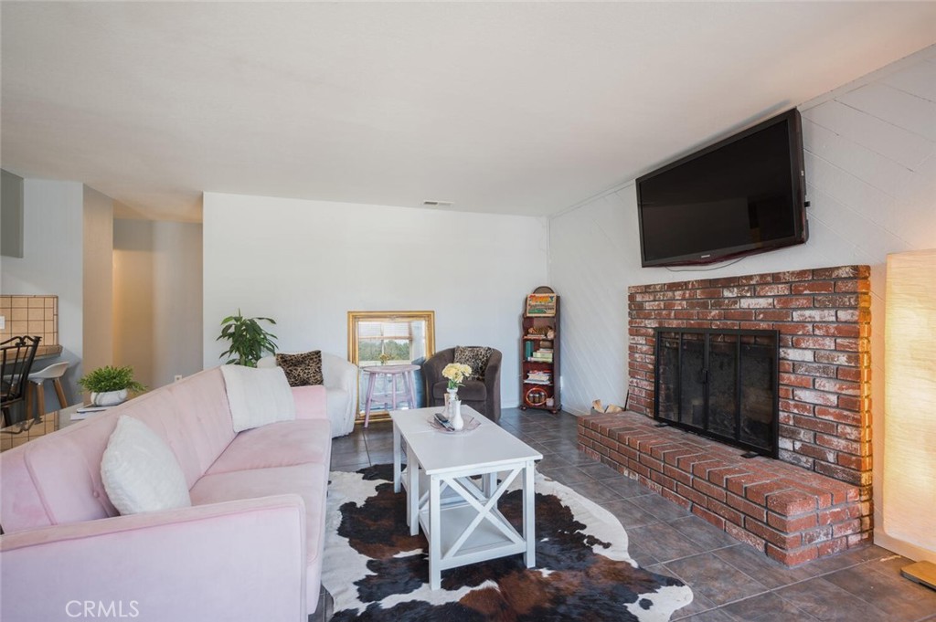 1503 17th Street Los Osos, CA 93402 - Photo 10 of 35 a living room with furniture a flat screen tv and a fireplace