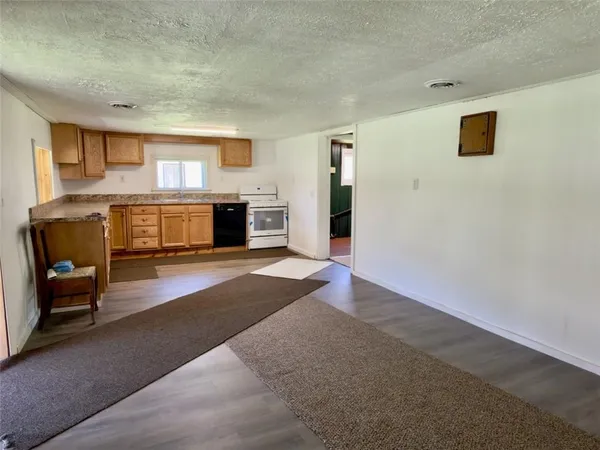 a view of a livingroom with a ceiling fan and window