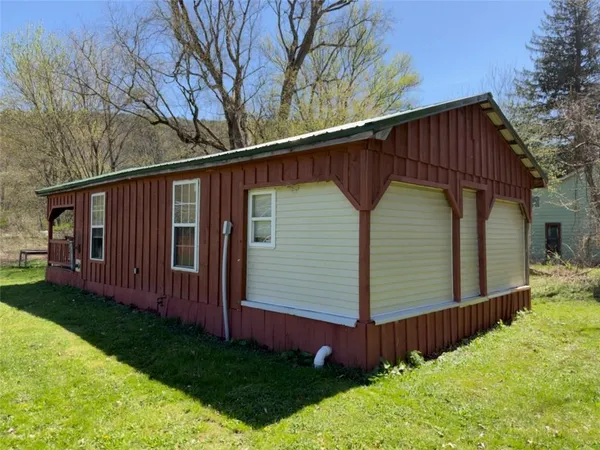 a view of a house with wooden fence