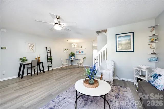 a living room with furniture and wooden floor