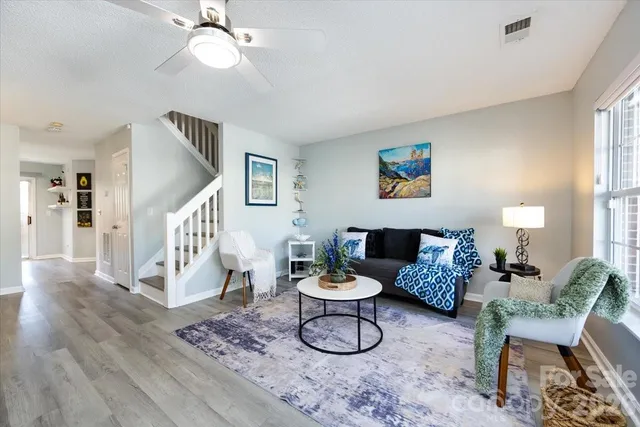 a living room with furniture and white walls