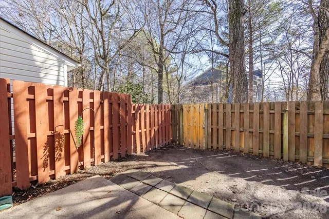 a view of a backyard with wooden fence