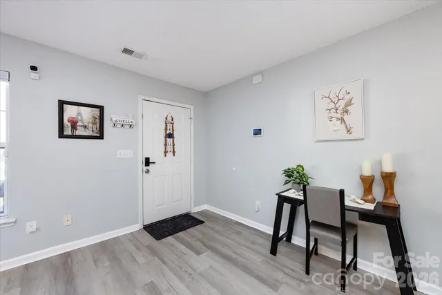 a view of a workspace with furniture and wooden floor