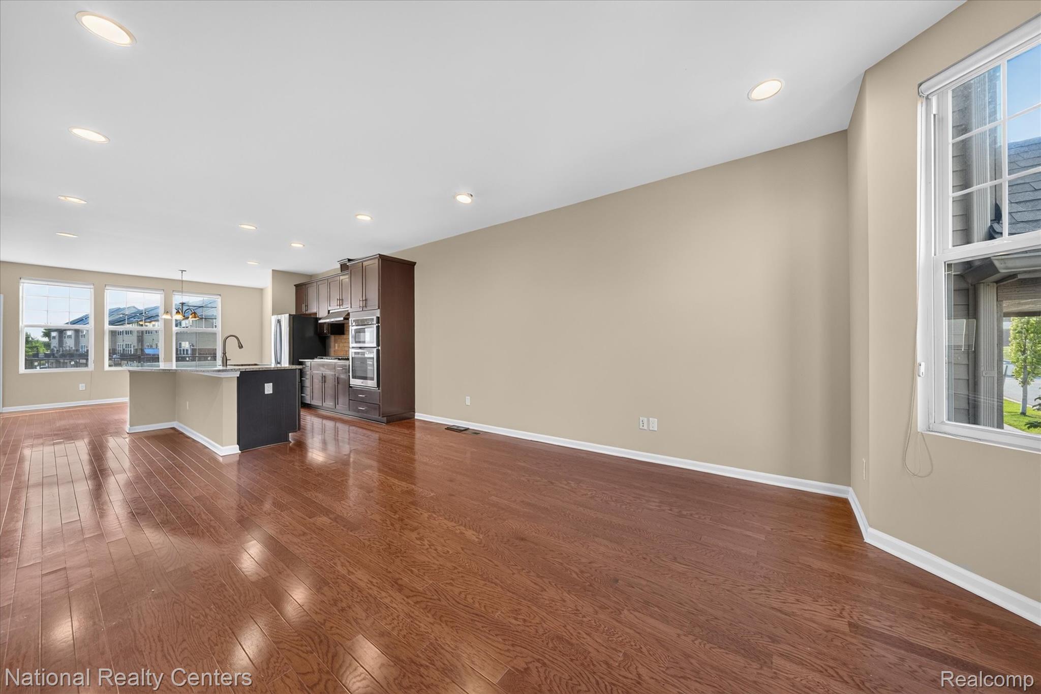 330 Glenhurst Boulevard Rochester, MI 48307 - Photo 13 of 47 Open-concept living space with wood-finish flooring, recessed lighting, a kitchen island, and stainless steel appliances