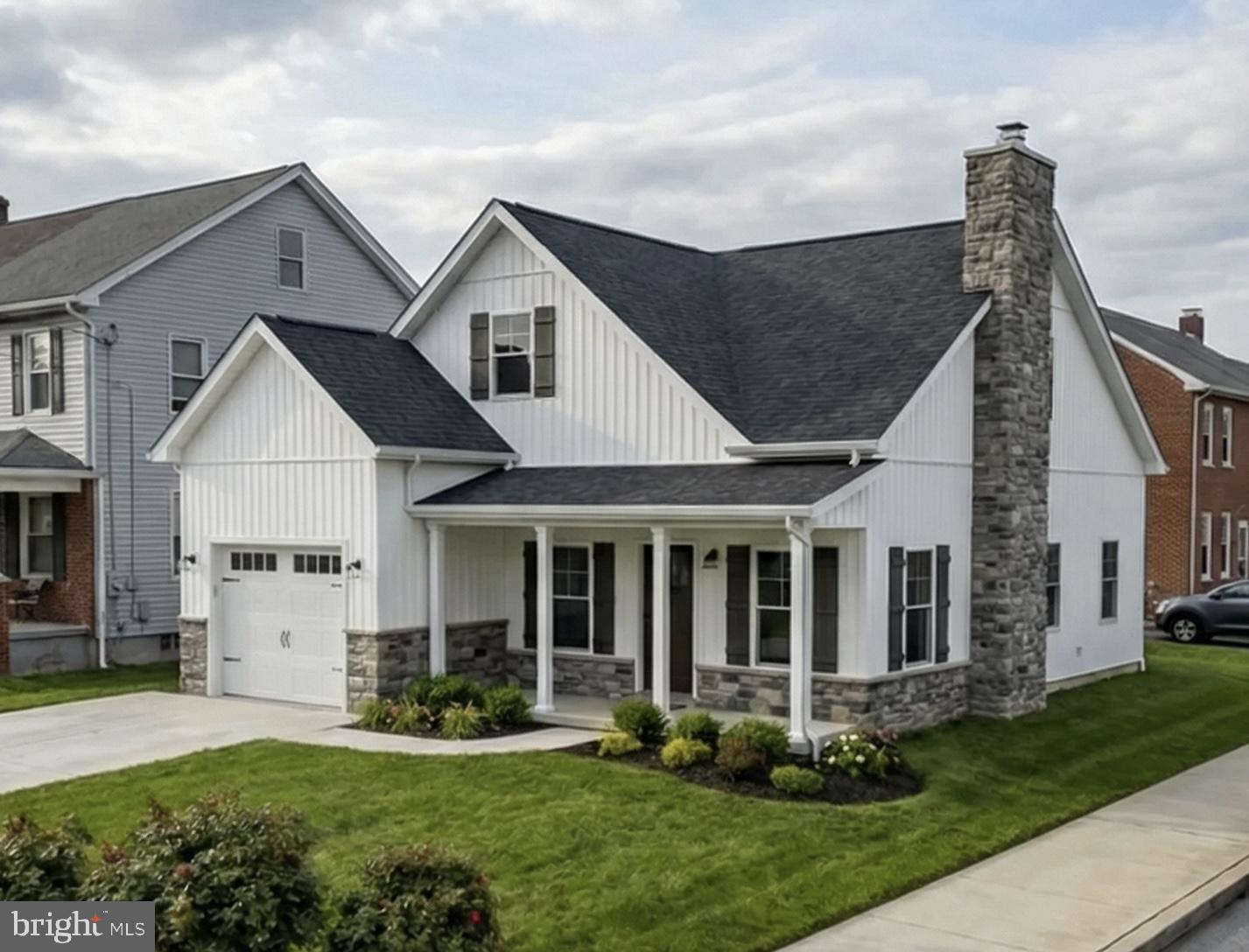 a front view of a house with a yard and porch