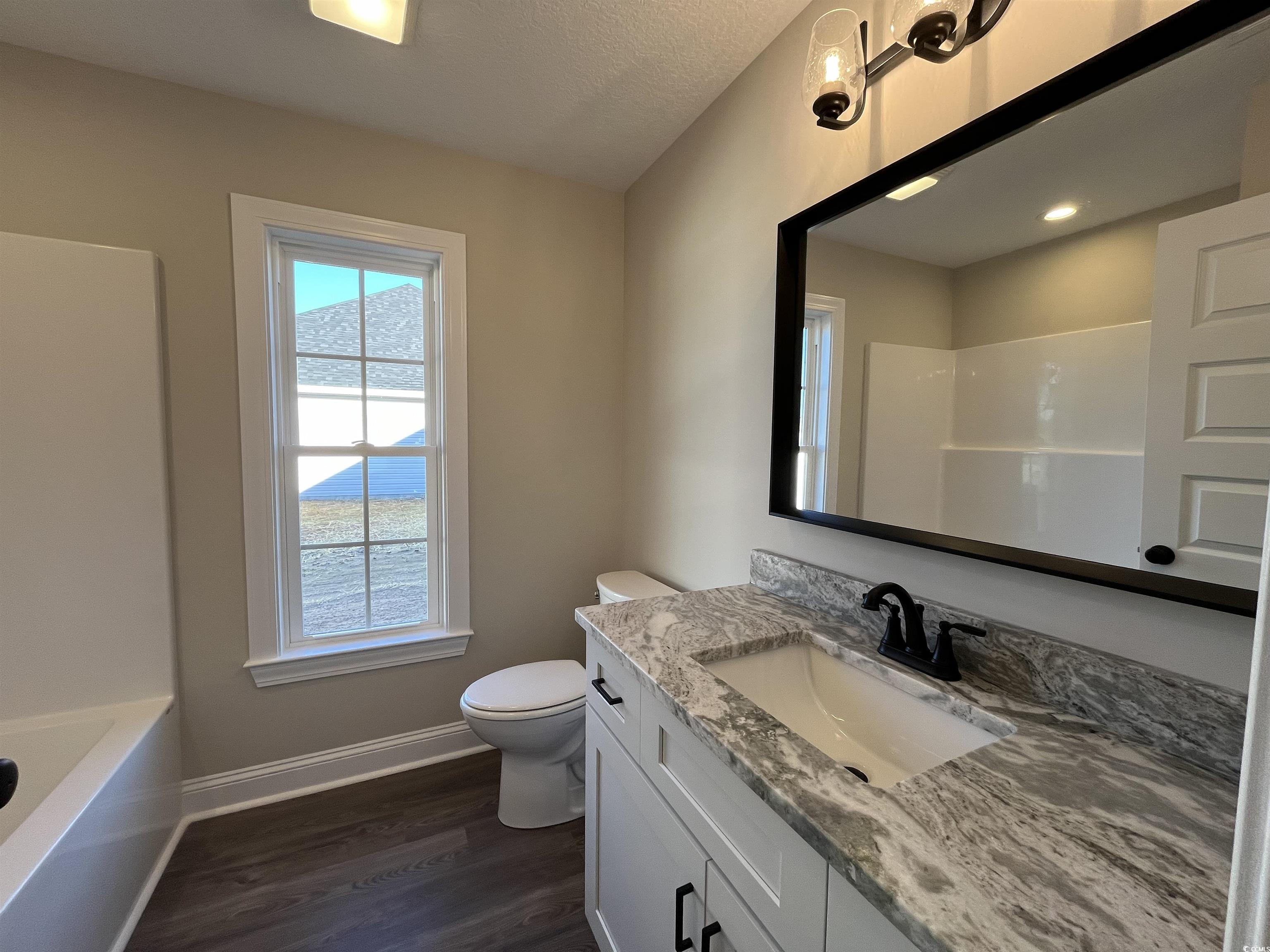 8201 Kerl Road Aynor, SC 29511 - Photo 15 of 20 Full bathroom with a textured ceiling, toilet, van