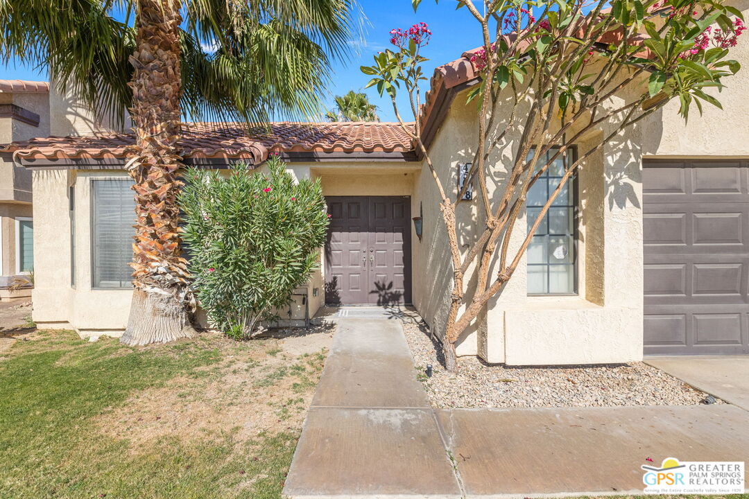 45688 Sutter Creek Road Indio, CA 92201 - Photo 5 of 51 a front view of a house with a yard and garage