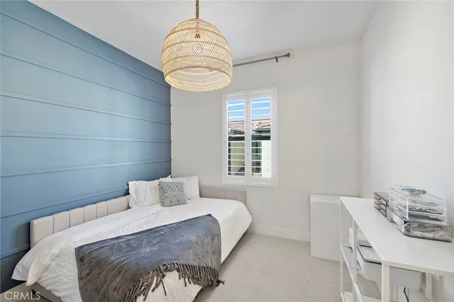 a bedroom with a bed and a chair