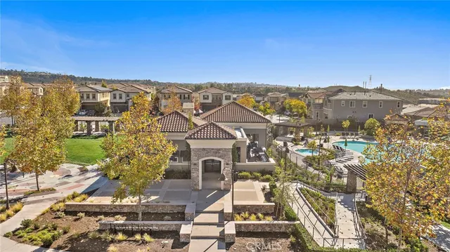 an aerial view of a swimming pool and outdoor seating