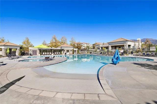 an outdoor space with swimming pool and furniture