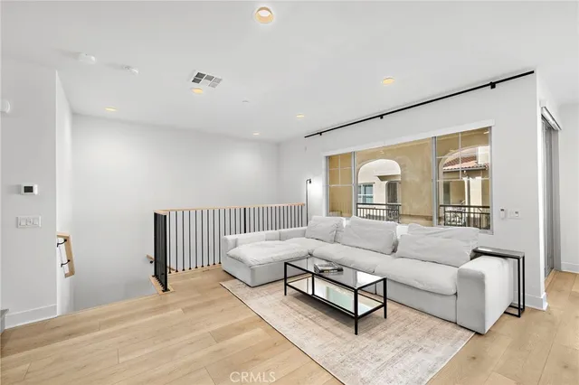 a spacious bedroom with a bed and a dresser in it