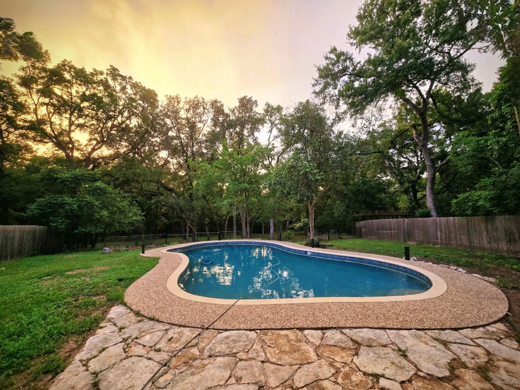 a view of a swimming pool with a yard