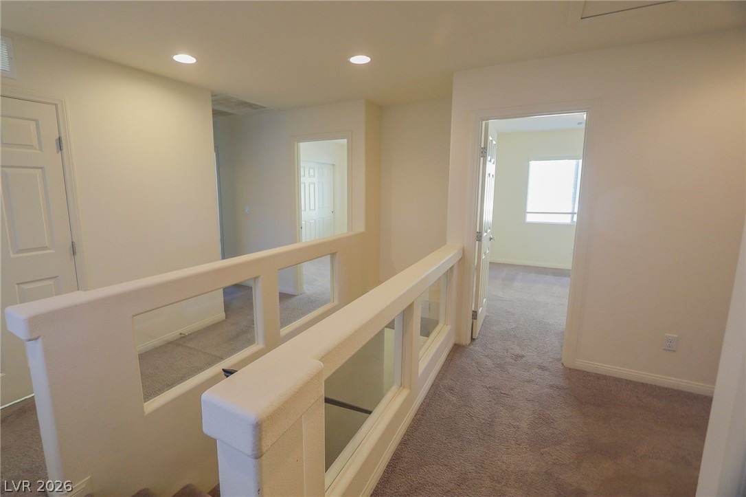 6418 Jackson Spring Road Las Vegas, NV 89118 - Photo 9 of 20 A well-lit landing and hallway on the upper level provide access to other rooms.