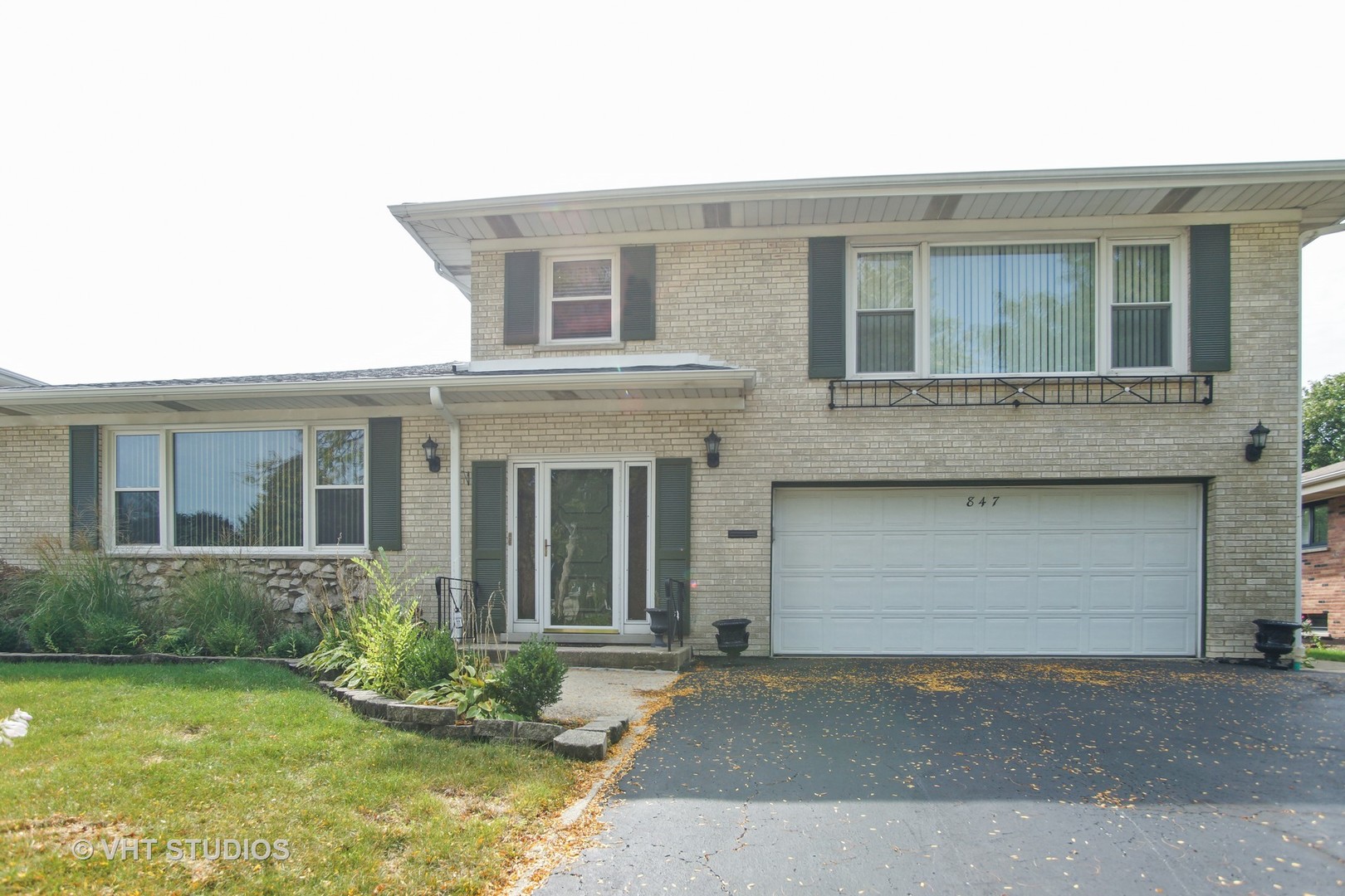 847 Heritage Drive, Unit 1 Addison, IL 60101 - Photo 1 of 10 a front view of a house with a yard and garage