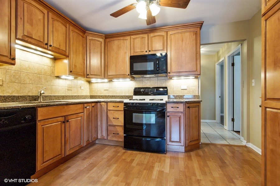847 Heritage Drive, Unit 1 Addison, IL 60101 - Photo 3 of 10 a kitchen with stainless steel appliances granite countertop a stove a sink dishwasher a refrigerator and a microwave oven