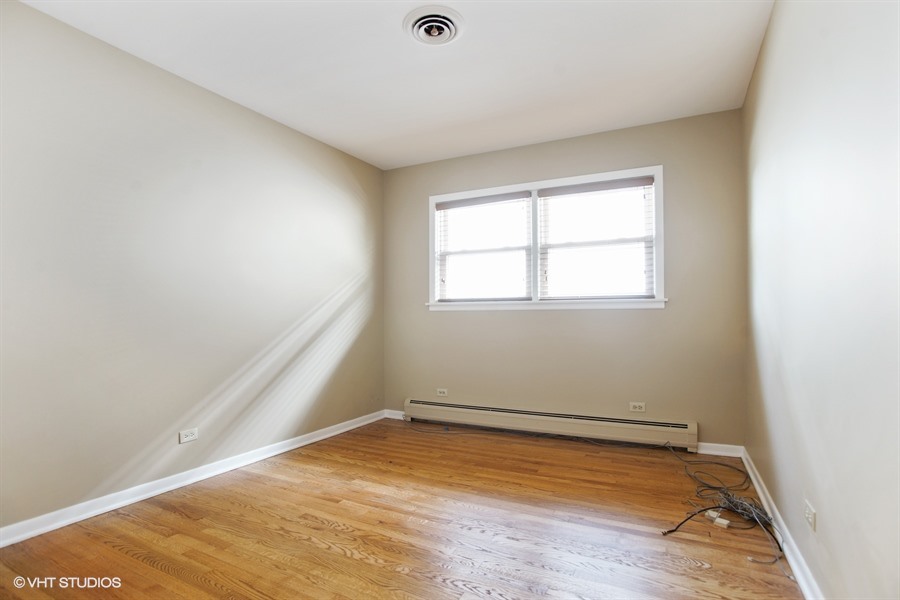 847 Heritage Drive, Unit 1 Addison, IL 60101 - Photo 7 of 10 an empty room with wooden floor and windows