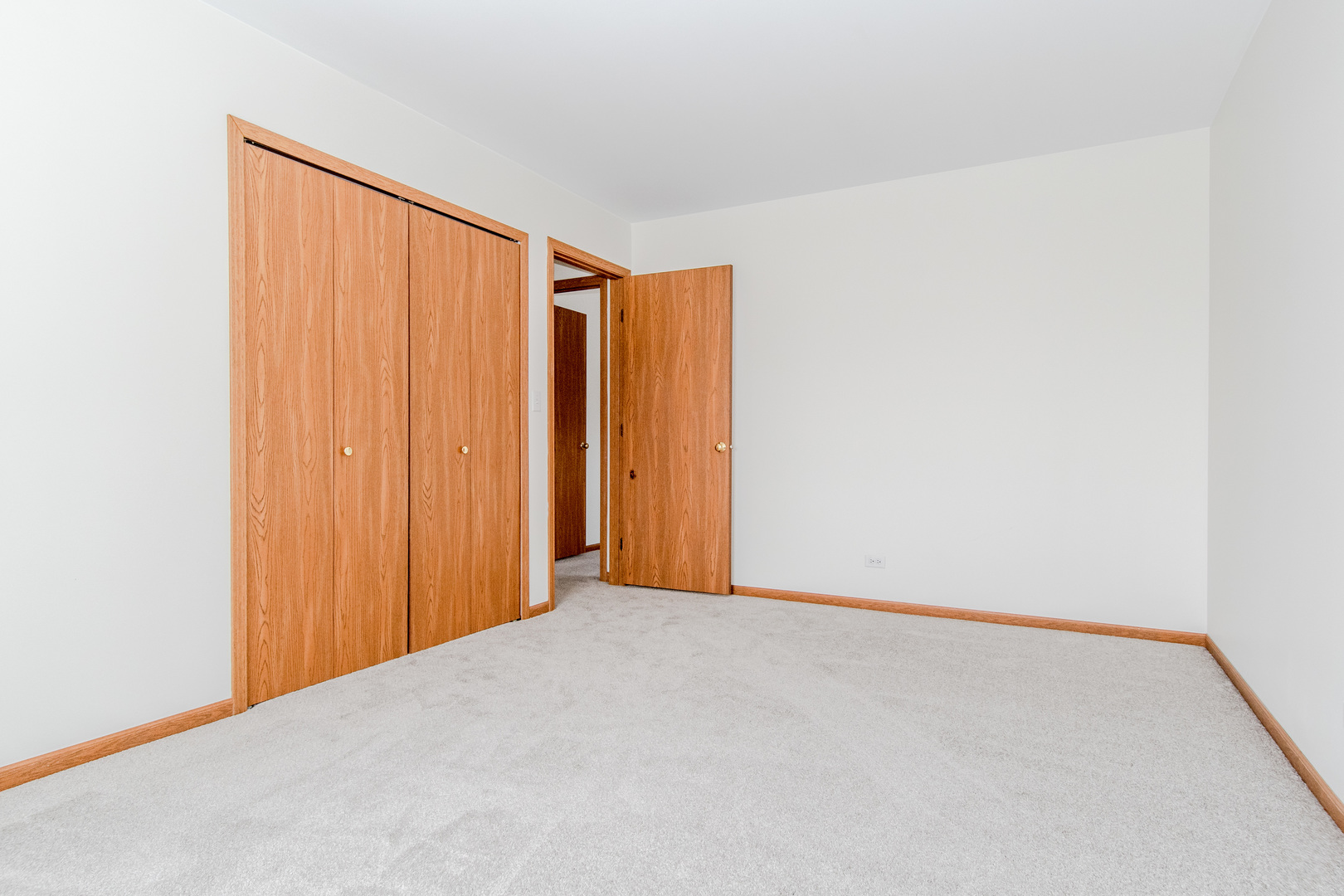 329 Sheffield Court, Unit 2 Roselle, IL 60172 - Photo 20 of 28 a view of a room with a wooden floor and a window