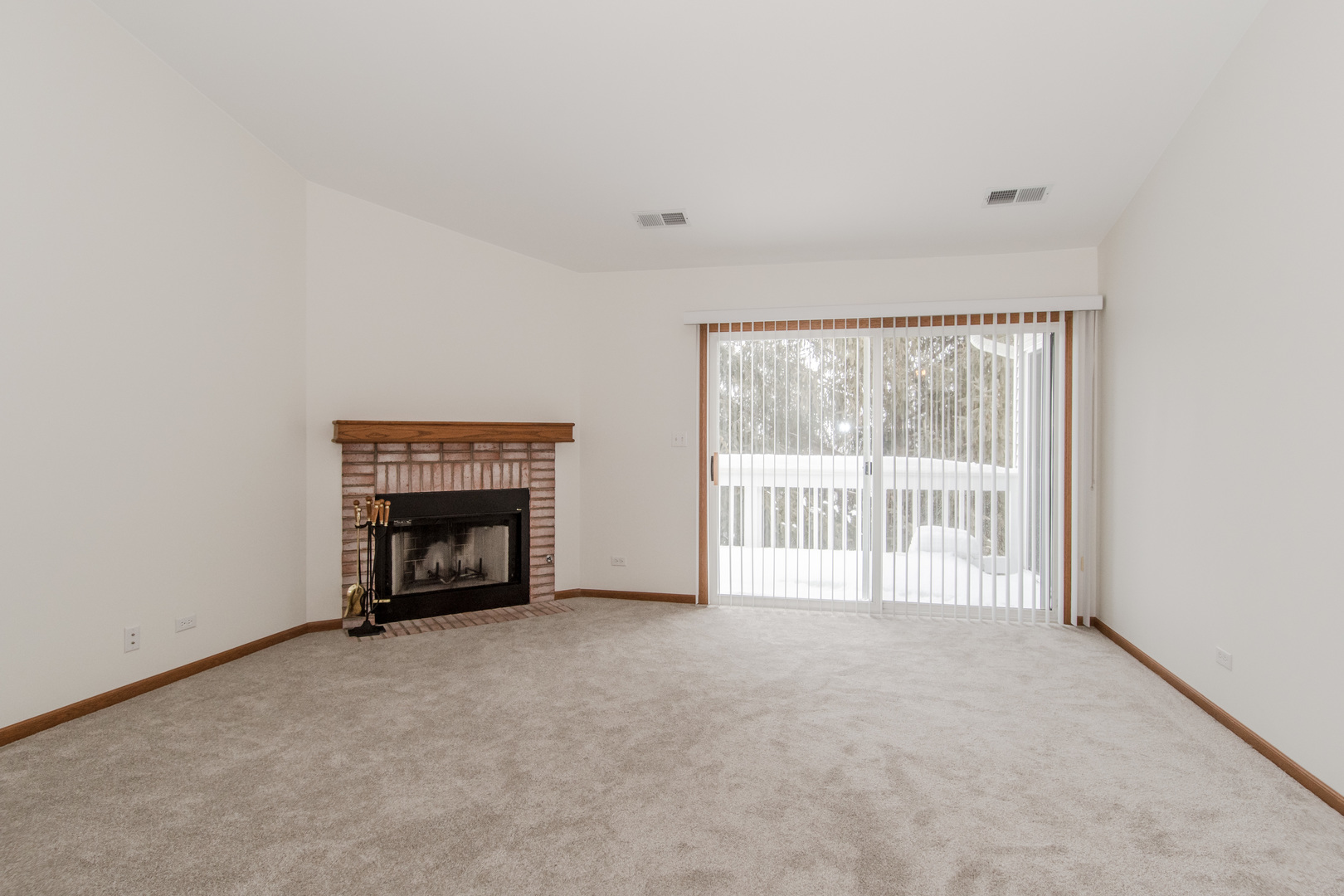 329 Sheffield Court, Unit 2 Roselle, IL 60172 - Photo 3 of 28 a view of an empty room with a fireplace and a window