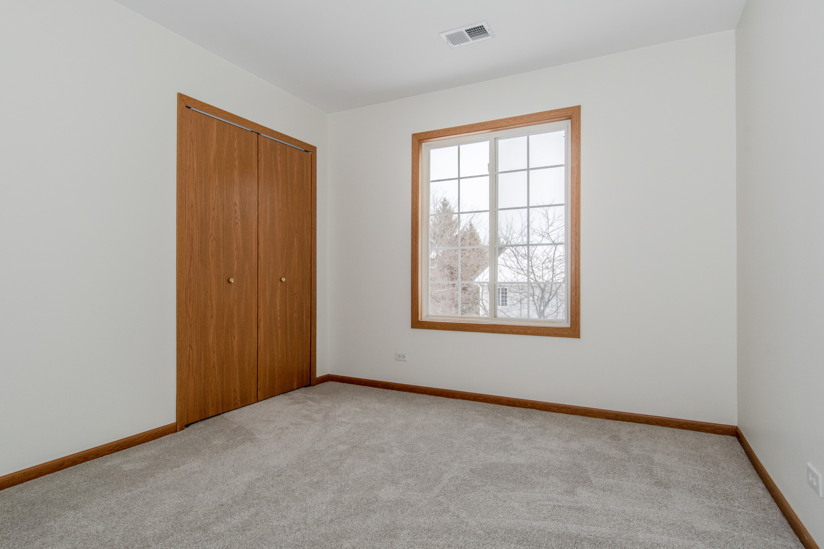 329 Sheffield Court, Unit 2 Roselle, IL 60172 - Photo 21 of 28 an empty room with windows