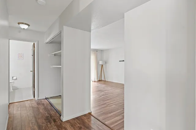 a view of hallway with wooden floor
