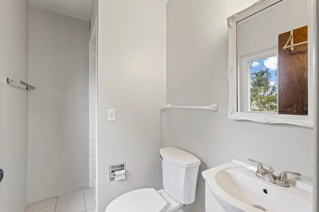 a white toilet sitting next to a bathroom sink