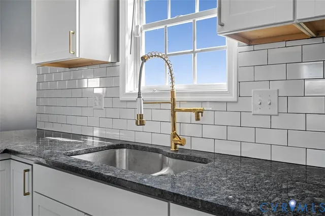 a kitchen with granite countertop a sink and a window