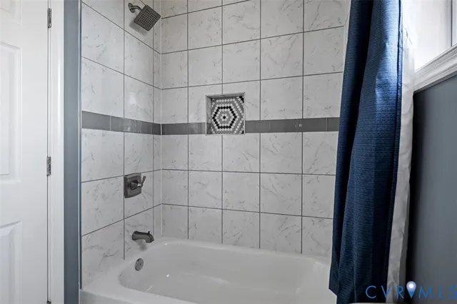 a bathroom with a bathtub and shower