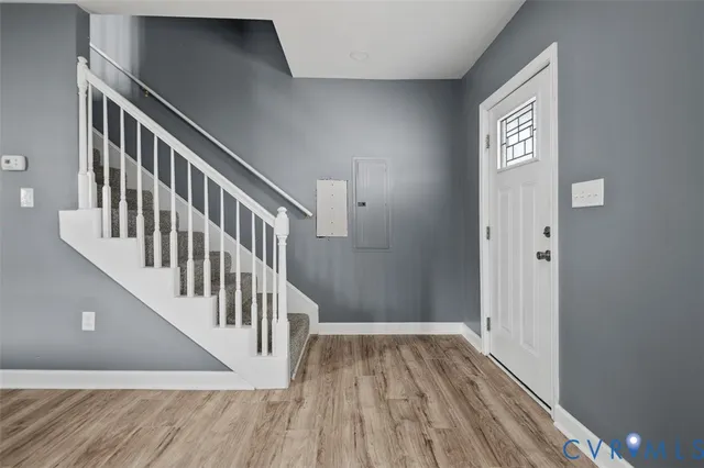 a view of an entryway with wooden floor