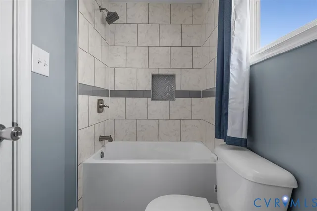 a bathroom with a bathtub and toilet