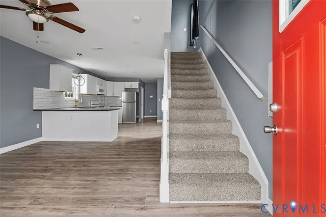 a view of entryway and hall with wooden floor