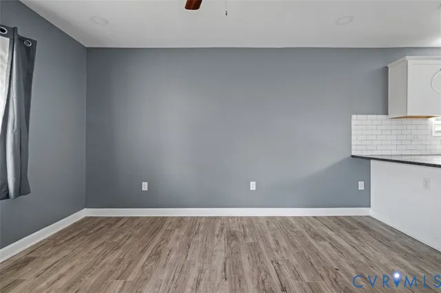 a view of an empty room and wooden floor