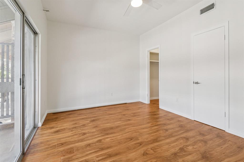 10754 Villager Road, Unit D Dallas, TX 75230 - Photo 12 of 37 a view of an empty room with wooden floor