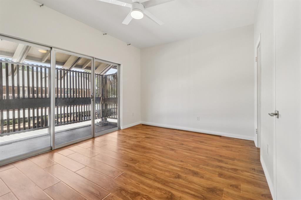 10754 Villager Road, Unit D Dallas, TX 75230 - Photo 13 of 37 a view of an empty room with wooden floor