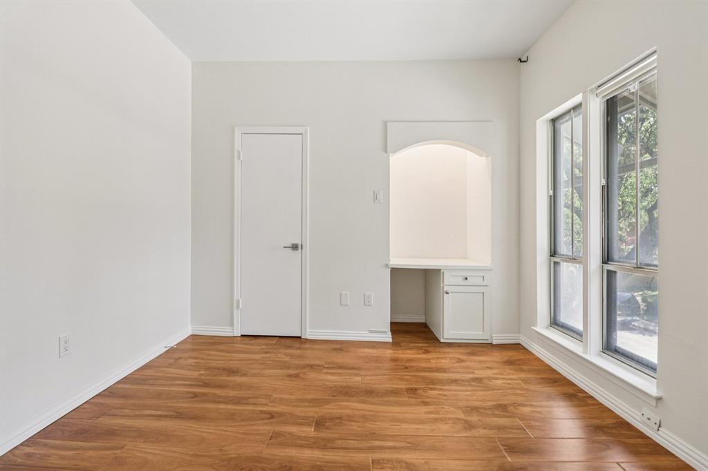 10754 Villager Road, Unit D Dallas, TX 75230 - Photo 18 of 37 a view of empty room with wooden floor and fan