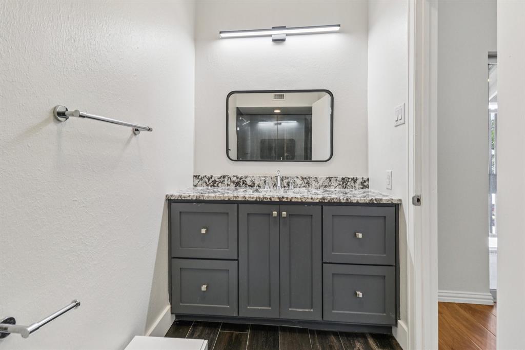 10754 Villager Road, Unit D Dallas, TX 75230 - Photo 24 of 37 a bathroom with a sink and a mirror