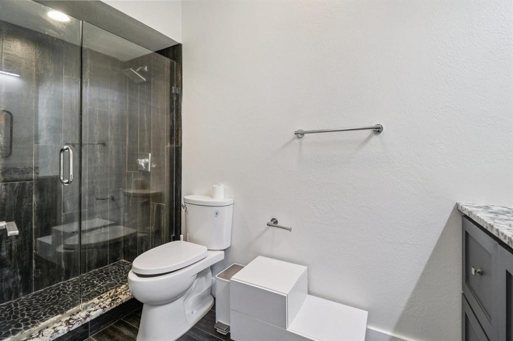 10754 Villager Road, Unit D Dallas, TX 75230 - Photo 25 of 37 a bathroom with a toilet and a shower
