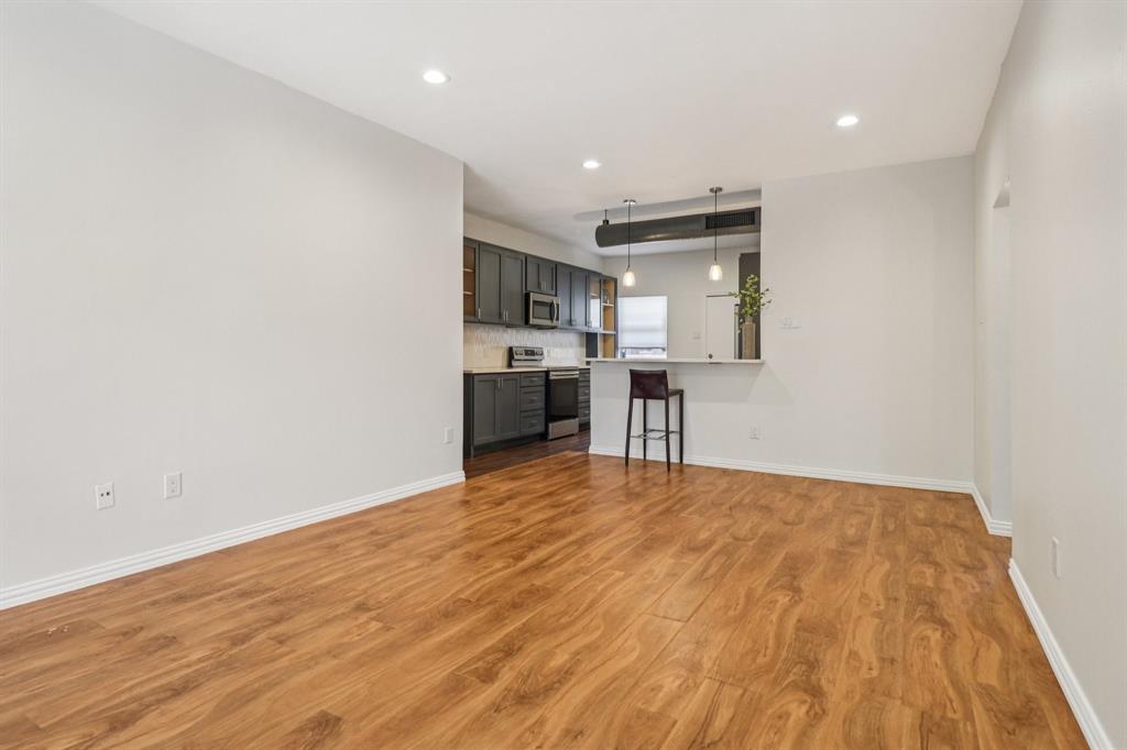 10754 Villager Road, Unit D Dallas, TX 75230 - Photo 31 of 37 a view of kitchen and wooden floor