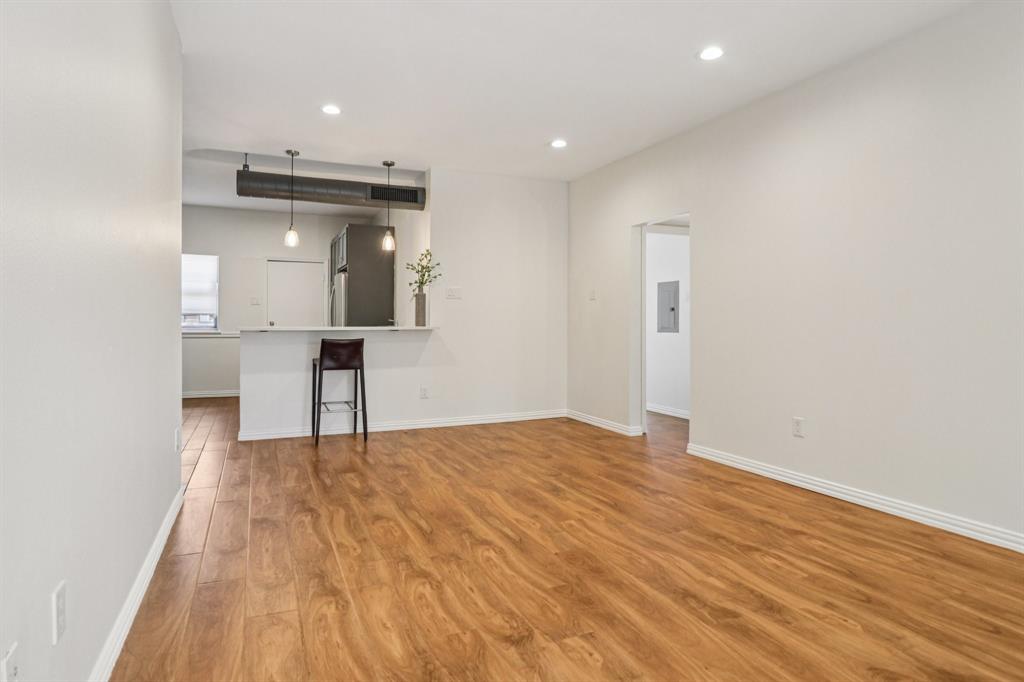 10754 Villager Road, Unit D Dallas, TX 75230 - Photo 9 of 37 a view of empty room with wooden floor