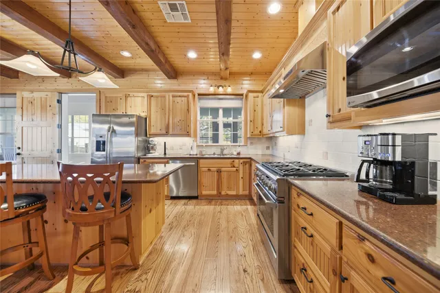 a kitchen with counter top space and stainless steel appliances
