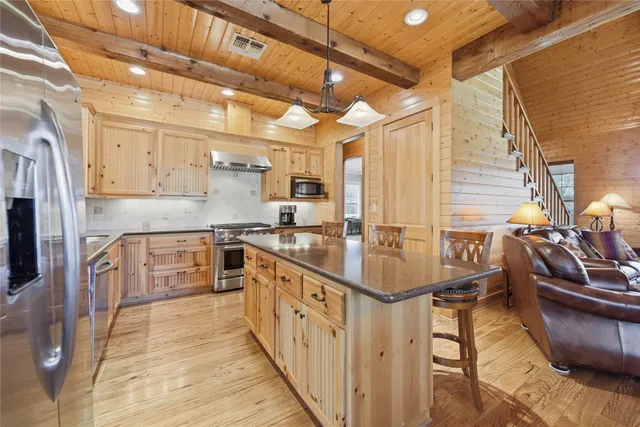 a kitchen with counter top space and wooden floor