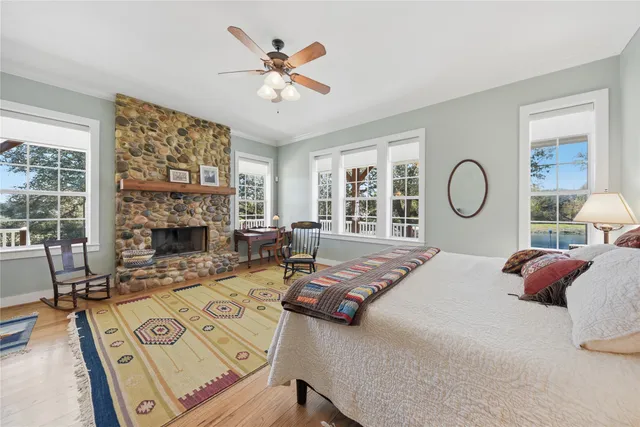 a view of staircase with wooden floor and fan