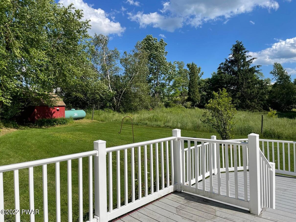 524 Creamton Drive Prompton, PA 18456 - Photo 56 of 57 a view of a wooden deck and yard with green space
