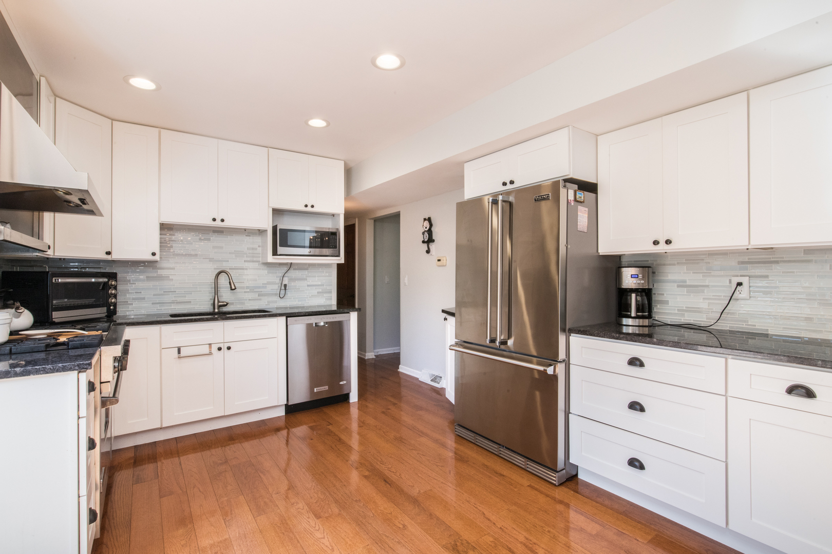 213 Forest View Drive Lake Bluff, IL 60044 - Photo 12 of 37 a kitchen with granite countertop a refrigerator oven a sink and white cabinets