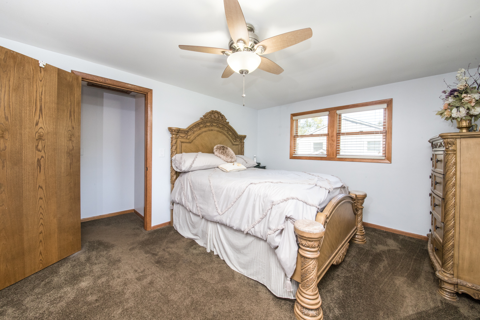 213 Forest View Drive Lake Bluff, IL 60044 - Photo 14 of 37 a bedroom with a bed and a chandelier