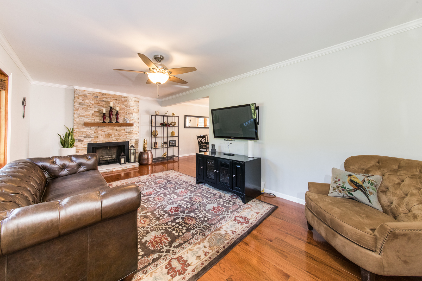 213 Forest View Drive Lake Bluff, IL 60044 - Photo 5 of 37 a living room with furniture a fireplace and a flat screen tv